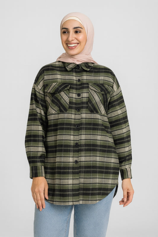 Woman wearing a plaid shirt and hijab on a white background