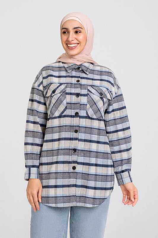 Woman wearing a plaid shirt and hijab on a white background